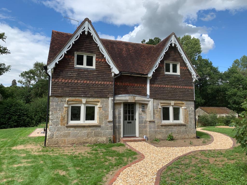 Restored Victorian estate cottage in East Sussex with decorative bargeboards, clay tile hanging and sandstone walls, renovated by Two Build